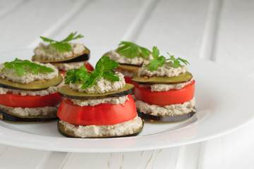 Slices of raw eggplant and tomato lined with layers of saute from the moistened raw sunflower seeds