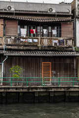 Old home near the polluted riverside. Poverty problem.traditional house.  Travel inspiration. Urban exploration. Vintage effect.