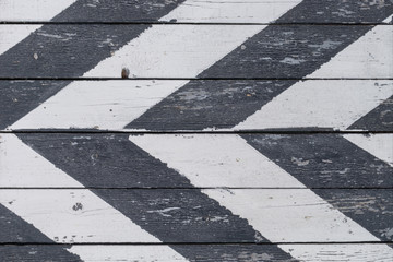 Wooden door to the warehouse, painted in oblique black stripes