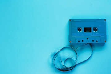 Retro cassette tape on blue background for audio recording and playback