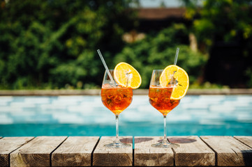 Two Glass of Aperol Spritz cocktail on the pool