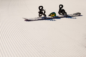 Equipment for snowboarding on a new groomed snow