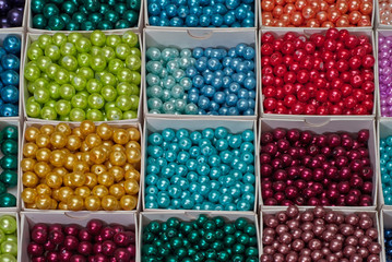 close up multi colored beads heap in box