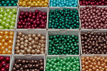 close up multi colored beads heap in box