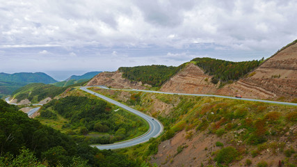 Curving Mountain Road in Scenic Landscape