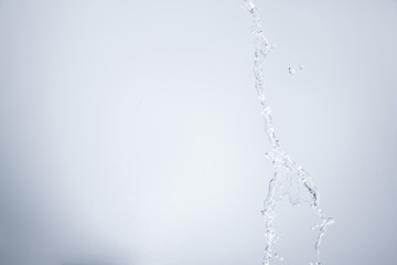 Naklejka na ściany i meble Water splashing on white background