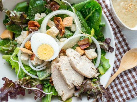 One Big Ceramic Bowl Of Ceasar Salad With Ceasar Dressing Cream.