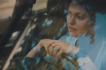 Smiling woman driving car, attractive girl sitting in automobile