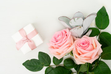 Two Rose fresh flowers on table from above with present and copy space, flat lay scene