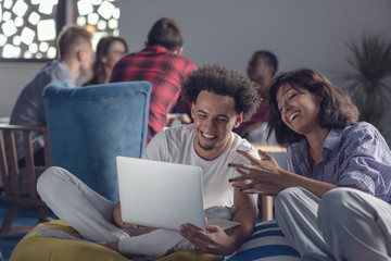 Fototapeta premium business, startup, technology and people concept - happy international creative team with laptop and tablet pc computer at office