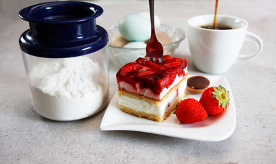 Delicious looking Strawberry cake with two strawberry fruits presented on a plate