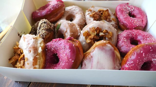 Closeup Of Opening A Box With Colorful Donuts With Glaze