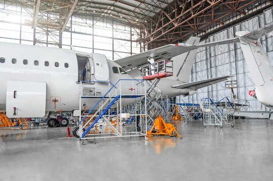 Passenger aircraft for maintenance of repair in the aviation hangar.