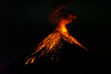 Lava going down the volcano Fuego in Antigua, Guatemala, right after an eruption by night. Natural...