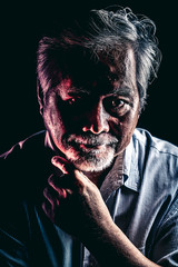 Rugged old man portrait, dramatic lighting.