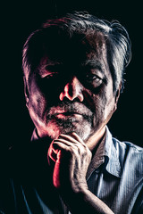 Rugged old man portrait, dramatic lighting.