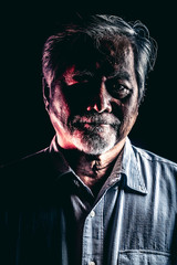 Rugged old man portrait, dramatic lighting.