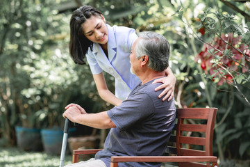 Nurse with patient sitting on bench together.