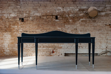 Black wooden console table with silver patina. Classic furniture