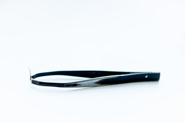 tweezers for plucking eyebrows. black on white background