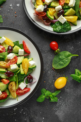 Fresh Greek salad with cucumber, cherry tomato, lettuce, red onion, feta cheese and black olives. Healthy food