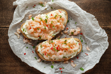 Prawns, shrimp seafood bruschetta with creamy cheese, parsley and chili