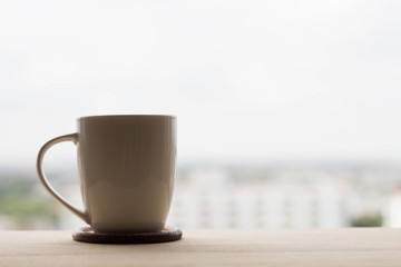White cup hot coffee  on wooden table.With Space for text.