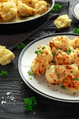 Roasted cauliflower with cheddar cheese sauce and herbs.