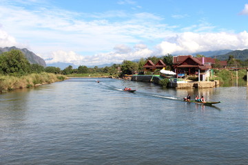 Fototapeta premium vang, vieng, landscape, tourism, river, destination, song, motorboat, karst, nam, laos, nature, people, water, travel, outdoor, traditional, tropical, asian, rock, rural, scenic, mountain, transportat