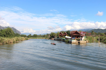 Fototapeta premium vang, vieng, landscape, tourism, river, destination, song, motorboat, karst, nam, laos, nature, people, water, travel, outdoor, traditional, tropical, asian, rock, rural, scenic, mountain, transportat