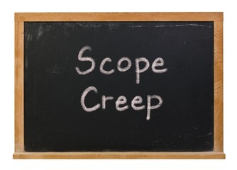 Scope creep written in white chalk on a black chalkboard isolated on white