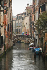 Fototapeta na wymiar Kleiner Kanal in Venedig mit Brücke bei Regen