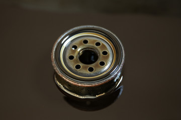 Used oil filter stands in old oil. The process of replacing the engine oil in a car
