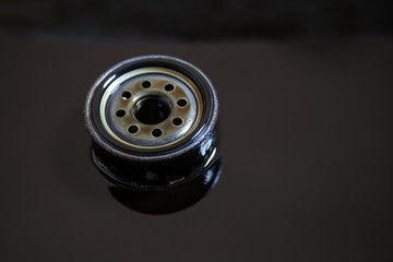 Used oil filter stands in old oil. The process of replacing the engine oil in a car