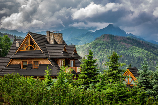 Fototapeta Clouds over Tatra Mountains and wooden cottage, Poland