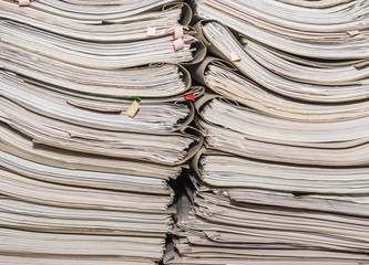 Old paper documents stacked in archive. Documents on the shelves of archive room. Office shelves in the closet full of files
