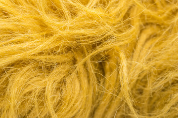 Yellow soft natural animal wool texture background. Skin wool. Close-up texture of white fluffy fur. Red plush