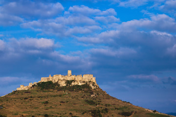 An eastern view of the Spis castle at sunrise with cloudy weather of early spring