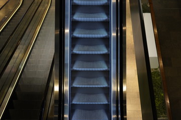 Illuminated escalator in a shopping mall