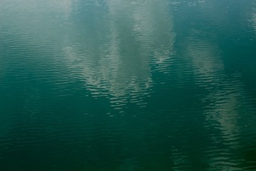 The reflection of the cloud in the sky on the water surface.