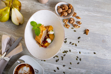 Close up view of beautiful elegant sweet dessert served, walnut roll, on the plate. Beautiful decoration, restaurant dish, ready to eat. Tea time, cozy atmosphere.