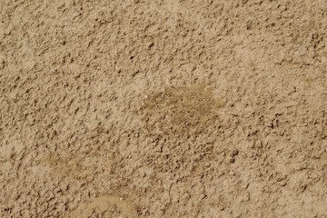 A close up view of the dirt on the ground surface texture of a baseball diamond.