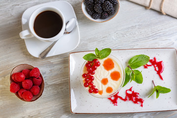 Close up view of beautiful elegant sweet dessert served, panacota, on the plate. Beautiful decoration, restaurant dish, ready to eat. Tea time, cozy atmosphere.
