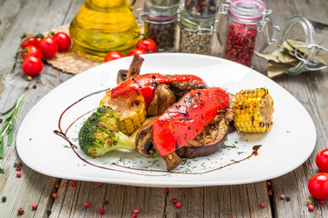 Grilled vegetables on a plate with sauce.