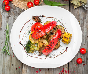 Grilled vegetables on a plate with sauce.