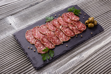 Saucisson sec delicious french salami on a wooden background
