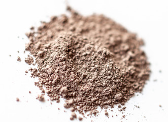 Natural colored pigment powder close up, matt eyeshadow pigment on a white background