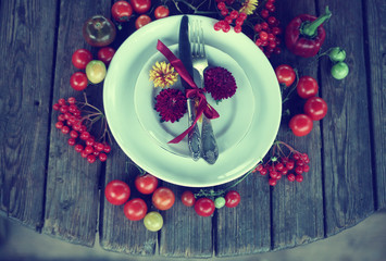 Thanksgiving day table settings with harvest pumpkins