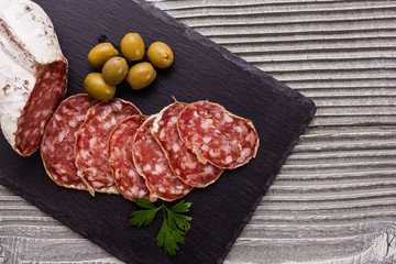 Saucisson sec delicious french salami on a wooden background
