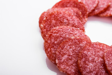 delicious sliced salami on a white background